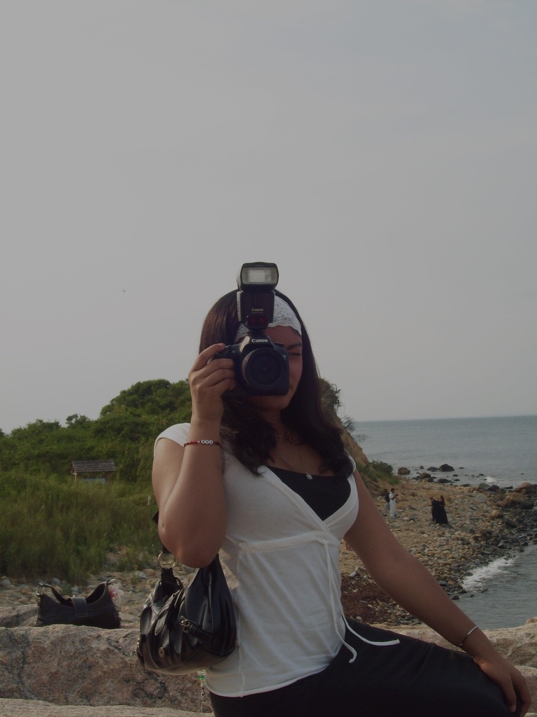 Leya with her camera by the coast