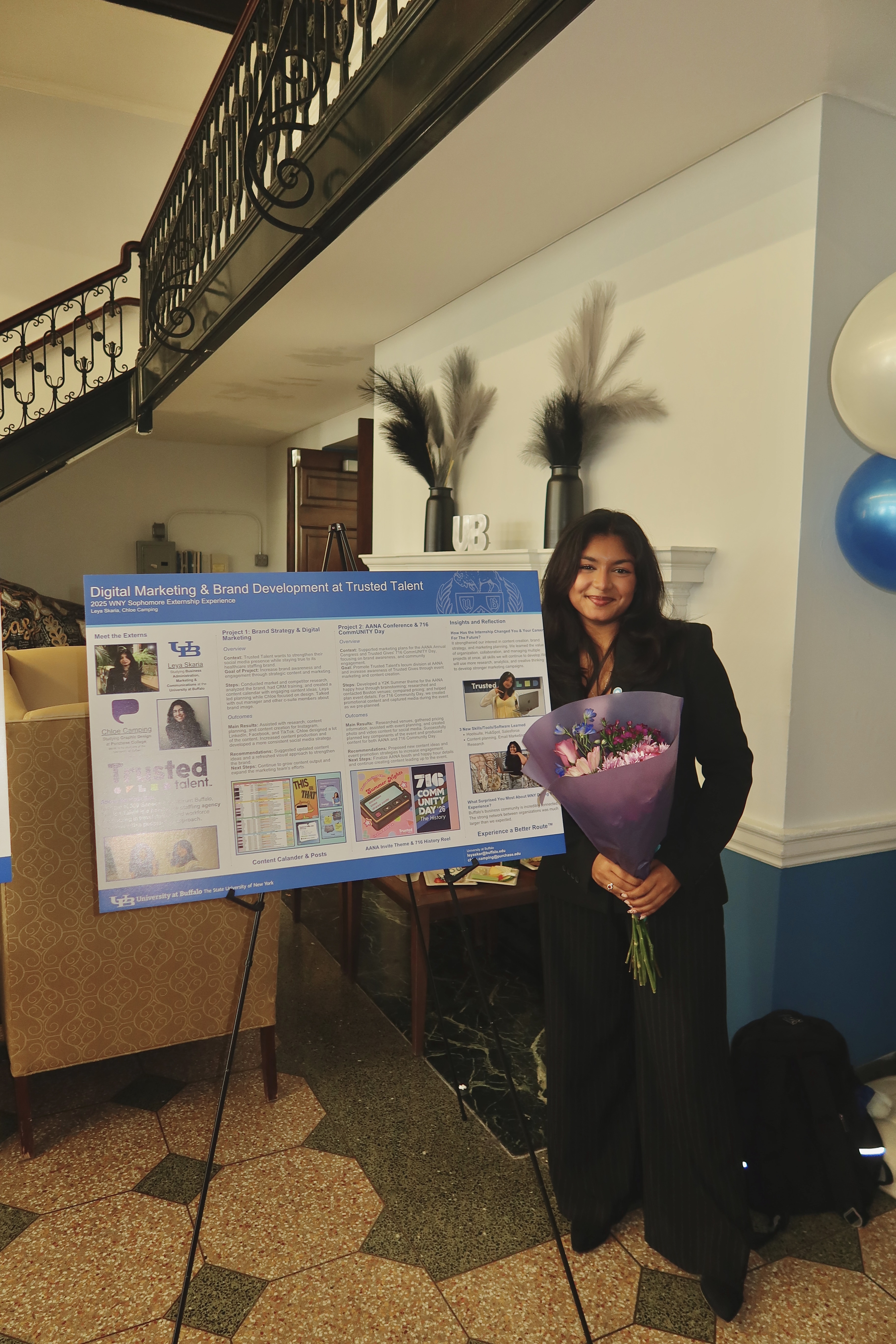 Leya beside her Trusted Talent SEE showcase board